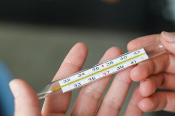 person holding thermometer